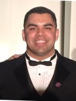 Photo of Isaac Juarez in a tuxedo smiling